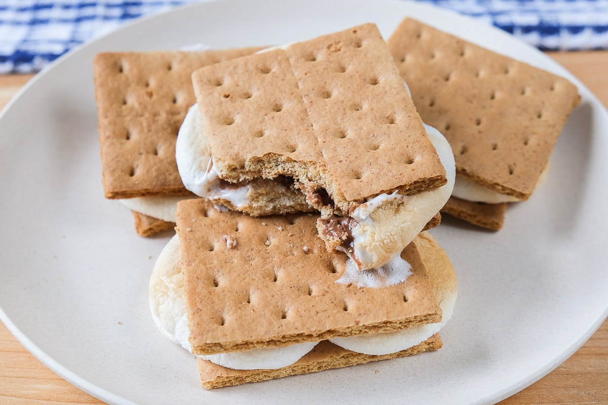toasted smores on white plate on wooden board