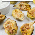 cooked artichoke hearts on white plate with text overlay "artichoke hearts in the air fryer".