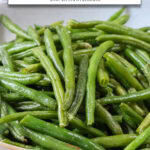 cooked green beans in bowl with text overlay 