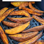 sweet potato wedges in black air fryer with text overlay "sweet potato wedges in the air fryer".