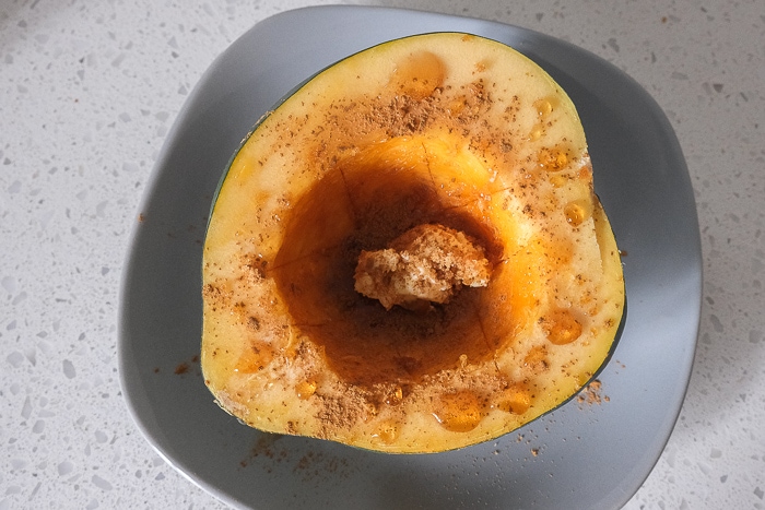 sweet ingredients inside half of acorn squash on gray plate