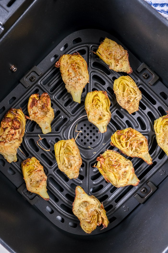 crispy artichoke hearts in black air fryer tray