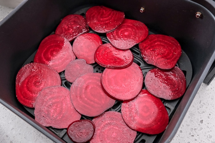 beet slices in black air fryer tray on counter