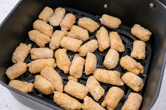 frozen veggie tots in black air fryer tray