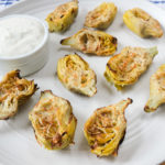 artichoke hearts with parmesan cheese on white plate