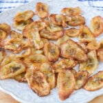 banana chips on floral plate on wooden board