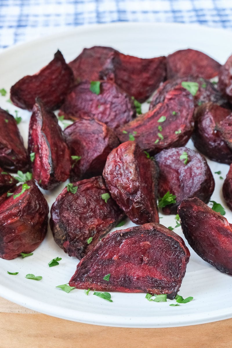 cooked beets on white plate with parsley