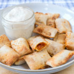 cooked pizza bites in bowl with dipping sauce behind