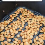 roasted pumpkin seeds in black air fryer with text overlay "pumpkin seeds in the air fryer".
