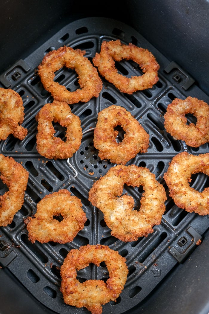 crispy breaded calamari rings in black air fryer tray