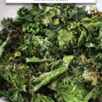 kale chips in bowl with text overlay with text overlay "kale chips in the air fryer".