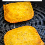 two jamaican beef patties in black air fryer with text overlay "air fryer frozen jamaican beef patties".