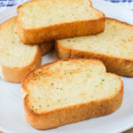 crispy pieces of texas toast on white plate on wooden board
