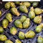 whole brussels sprouts in black air fryer with text overlay "frozen brussels sprouts in the air fryer".