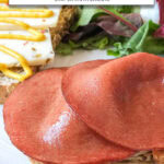 slices of fried bologna on slice of bread with text overlay "fried bologna in the air fryer".
