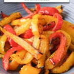 red and yellow bell pepper pieces in bowl with text overlay "bell peppers in the air fryer".