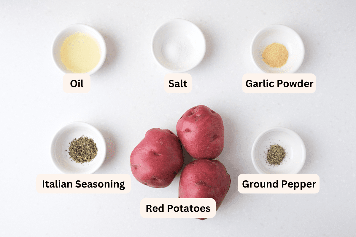 ingredients to make air fryer red potatoes on white counter with labels.