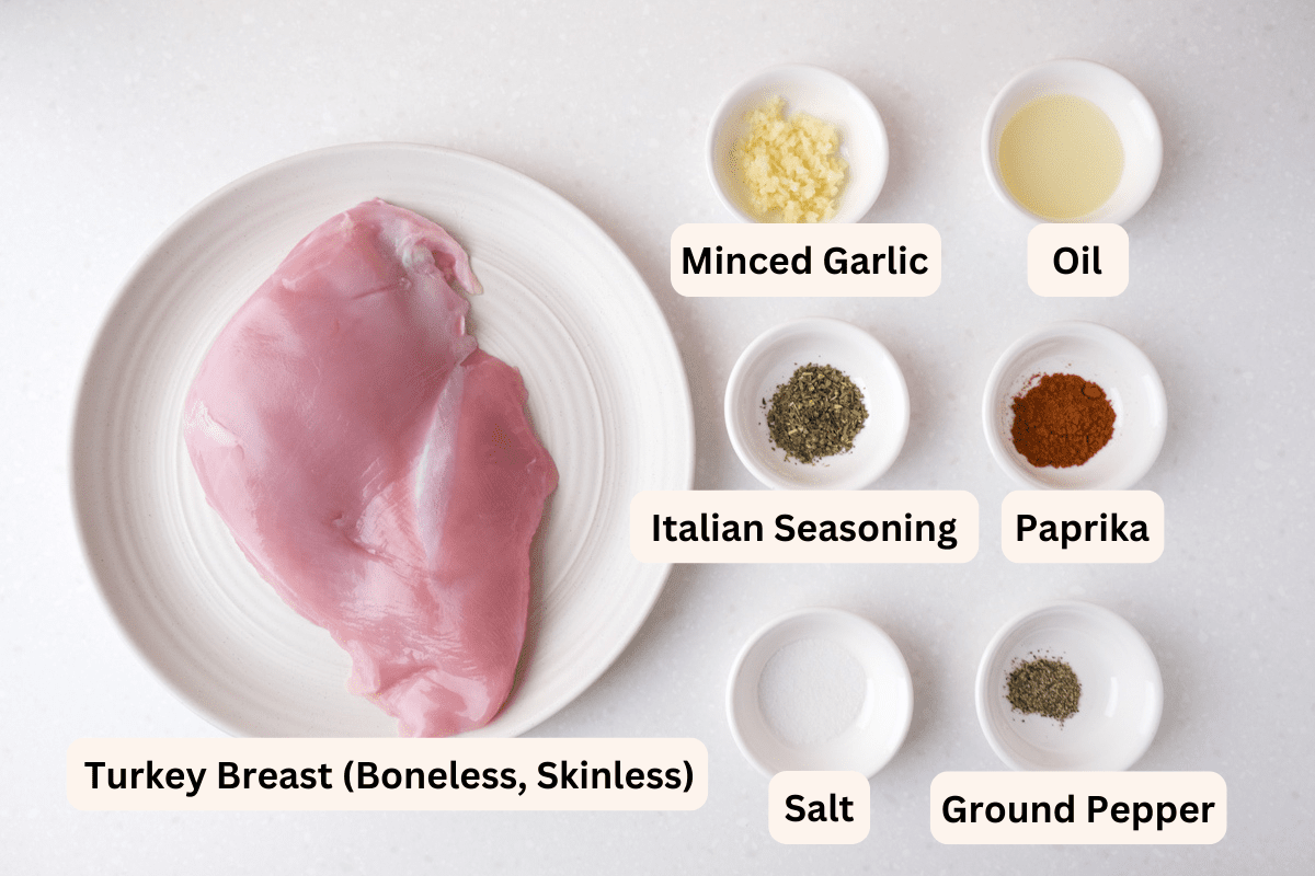 ingredients for turkey breast with spices in white bowls all labelled on white counter top.