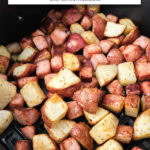cooked ham and potato cubes in black air fryer with text overlay "ham & potatoes in the air fryer".