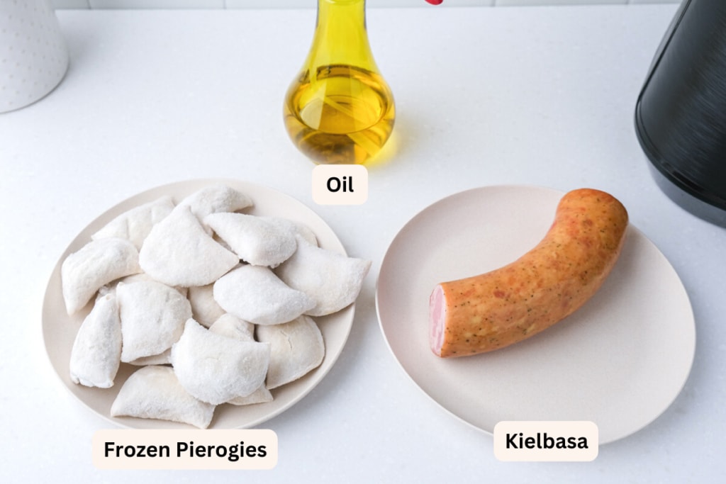 frozen pierogies and kielbasa on plates on white counter with oil behind and labels on everything.