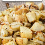 cooked potato cubes and onion slices in bowl with text overlay "potatoes & onions in the air fryer".