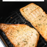 cooked salmon fillets with dill in air fryer with text overlay "salmon in the air fryer".