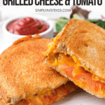 grilled cheese and tomato sandwich halves on white plate with text overlay "air fryer grilled cheese & tomato".