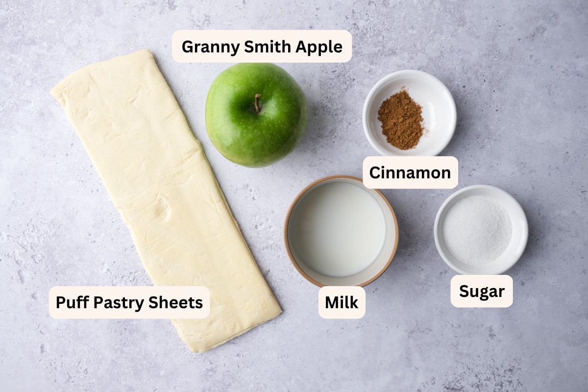 ingredients to make apple turnovers on grey counter with labels.