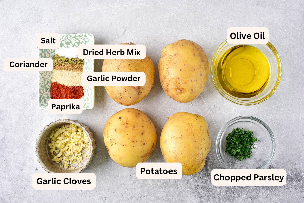 ingredients to make hasselback potatoes like spices in bowls with labels.