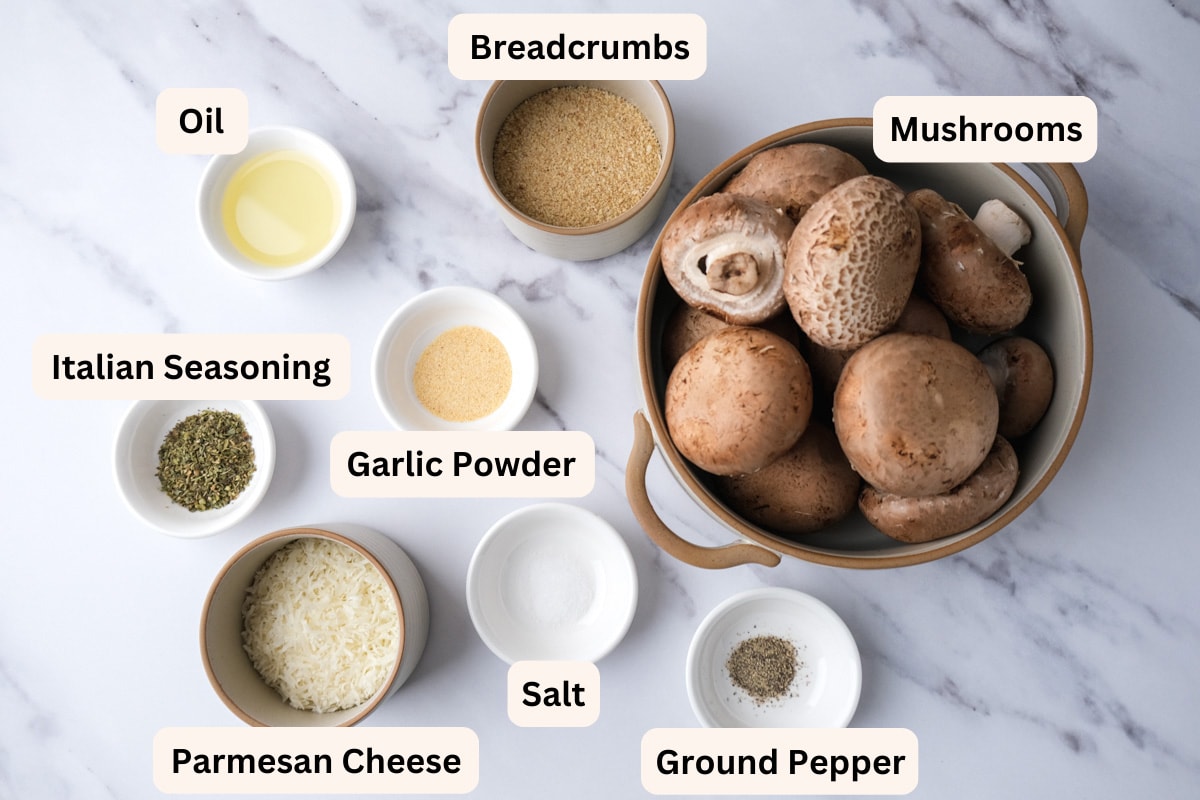 ingredients to make stuffed mushrooms on counter in bowls with labels.