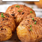 cooked hasselback potatoes on plate with text overlay 