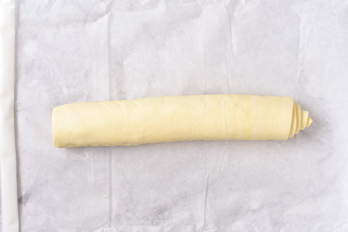 rolled puff pastry on parchment paper on counter top.