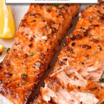 flaked, cooked honey garlic salmon on white plate with text overlay 
