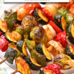 cooked vegetable skewers on plate with text overlay 