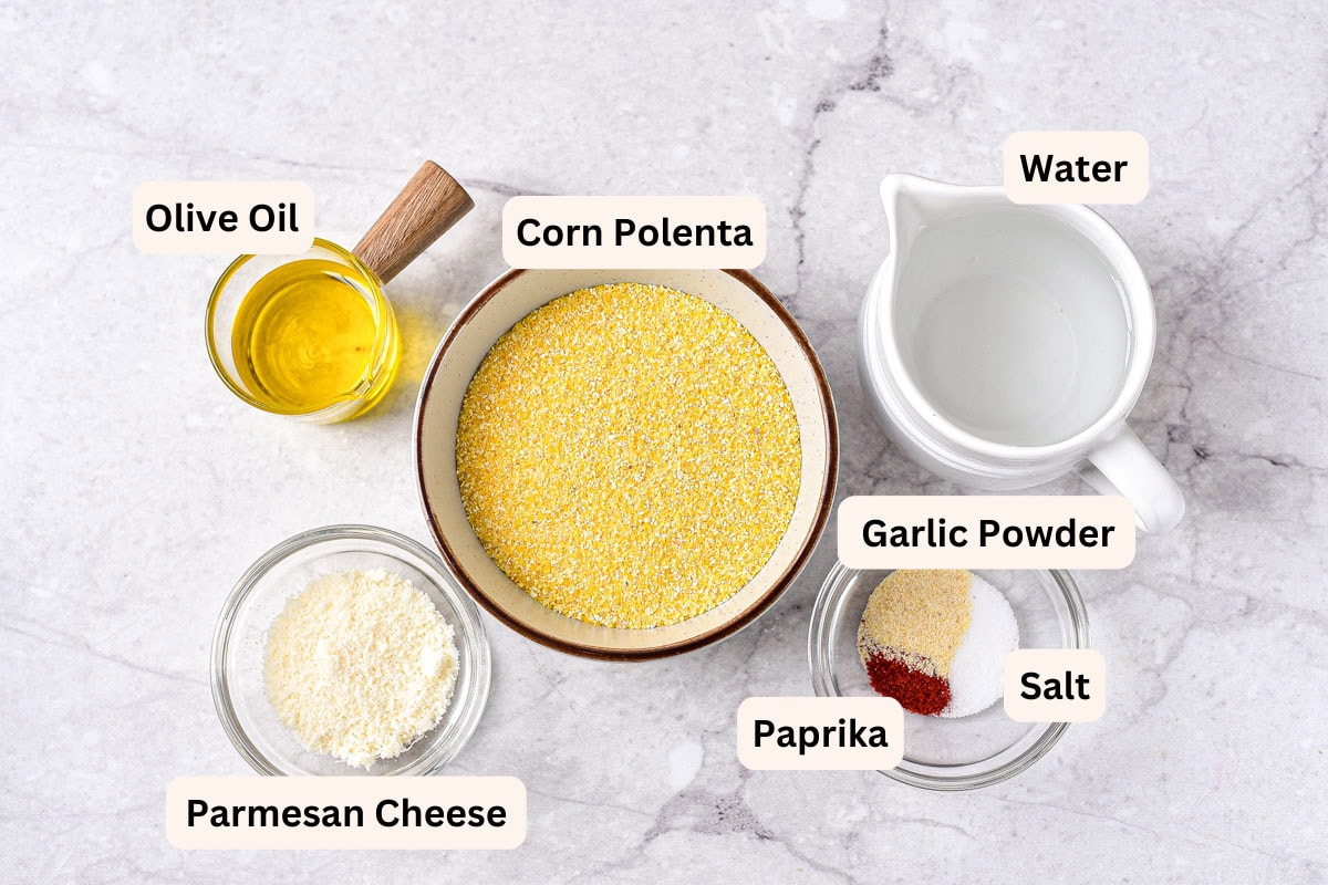 ingredients in bowls with labels to make polenta fries sitting on counter top.