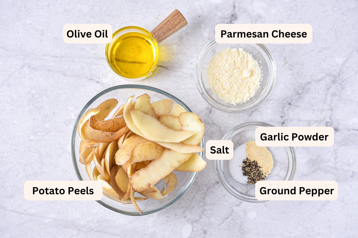 ingredients to make crispy potato peels on counter in bowls with labels.