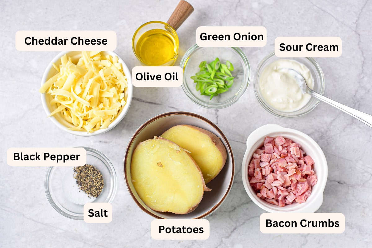 ingredients in bowls with labels on counter for potato skins.