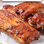 cooked ribs on plate with text overlay "pork ribs in the air fryer".