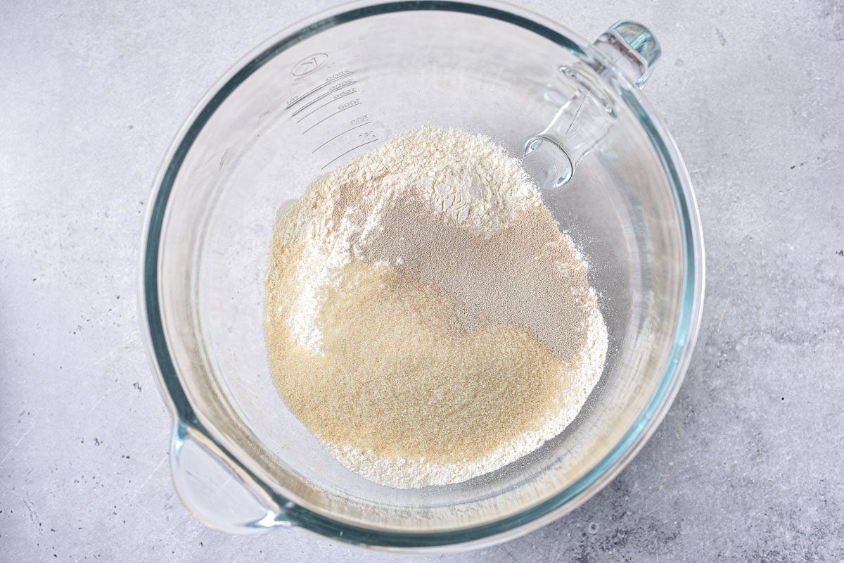 clear glass bowl filled with ingredients to make yeast dough.