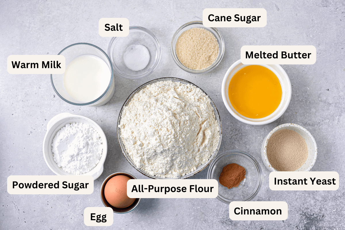 ingredients to make air fryer donuts in bowls on counter with labels.