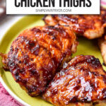 cooked bbq chicken thighs on green plate with text overlay "air fryer bbq chicken thighs".
