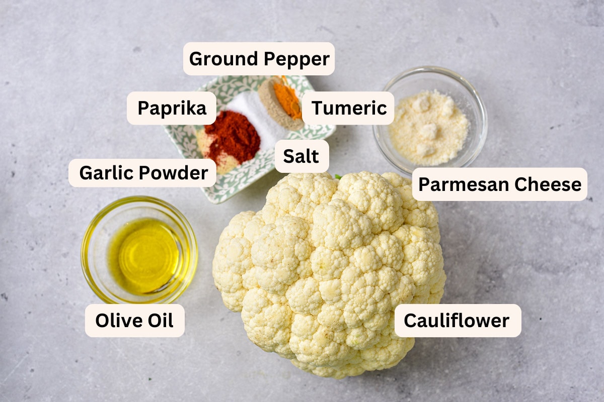 ingredients for cauliflower steaks in bowls on counter with labels.