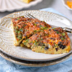 slices of frittata on plate with fork beside.