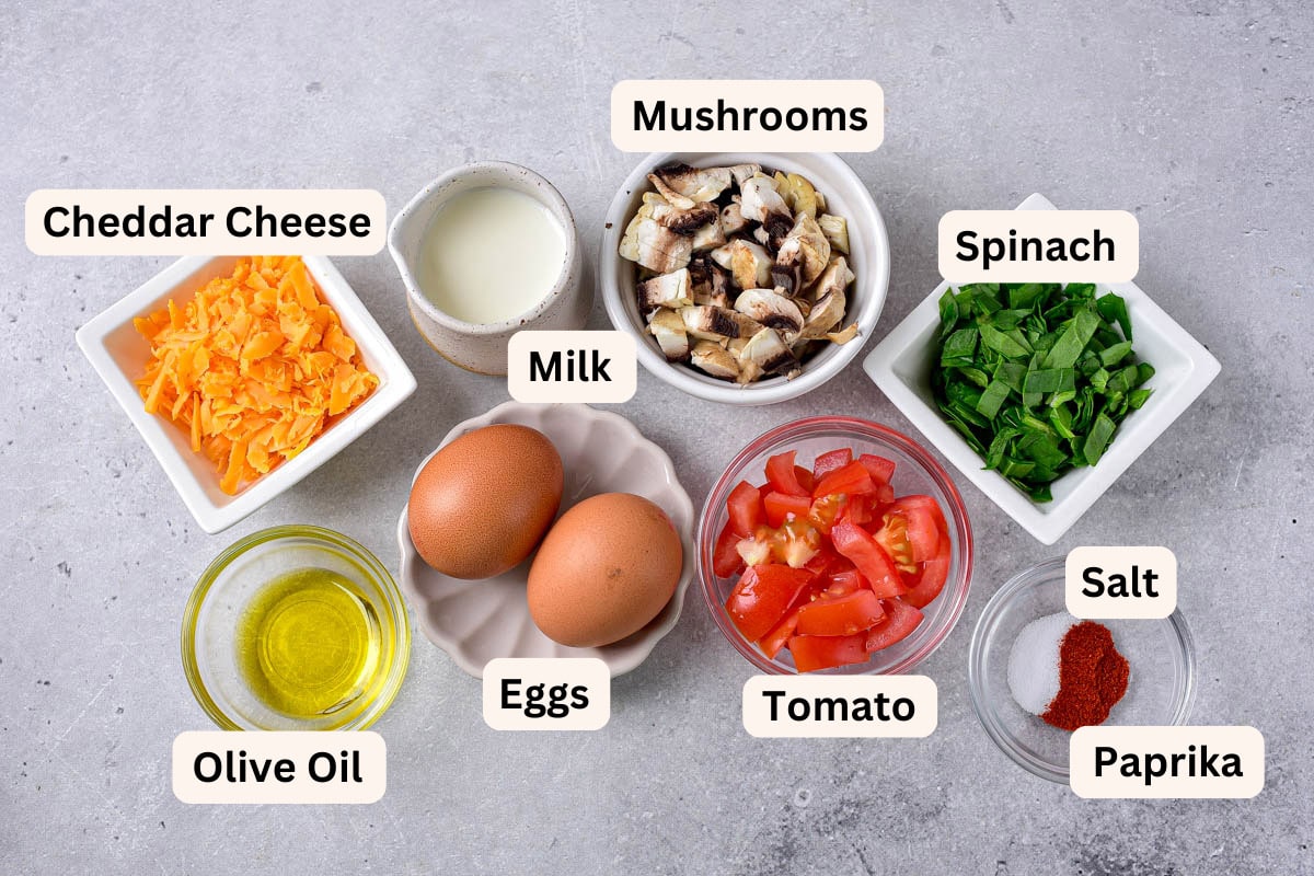 ingredients to make a frittata in bowls on counter with labels.