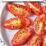 roasted seasoned tomatoes on plate with text overlay "roasted tomatoes in the air fryer".