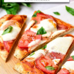 cut up naan pizza on cutting board with text overlay "air fryer naan pizza".