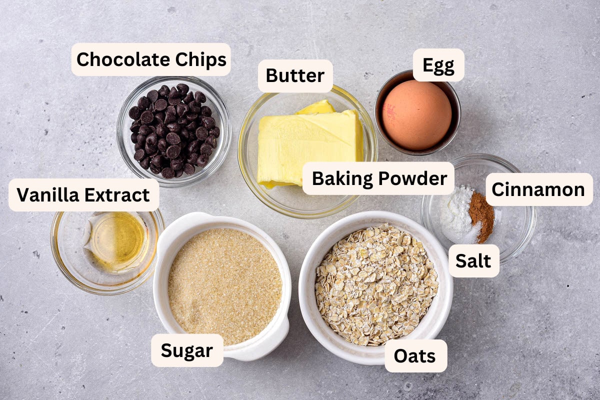 ingredients to make air fryer oatmeal cookies on counter in bowls with labels.