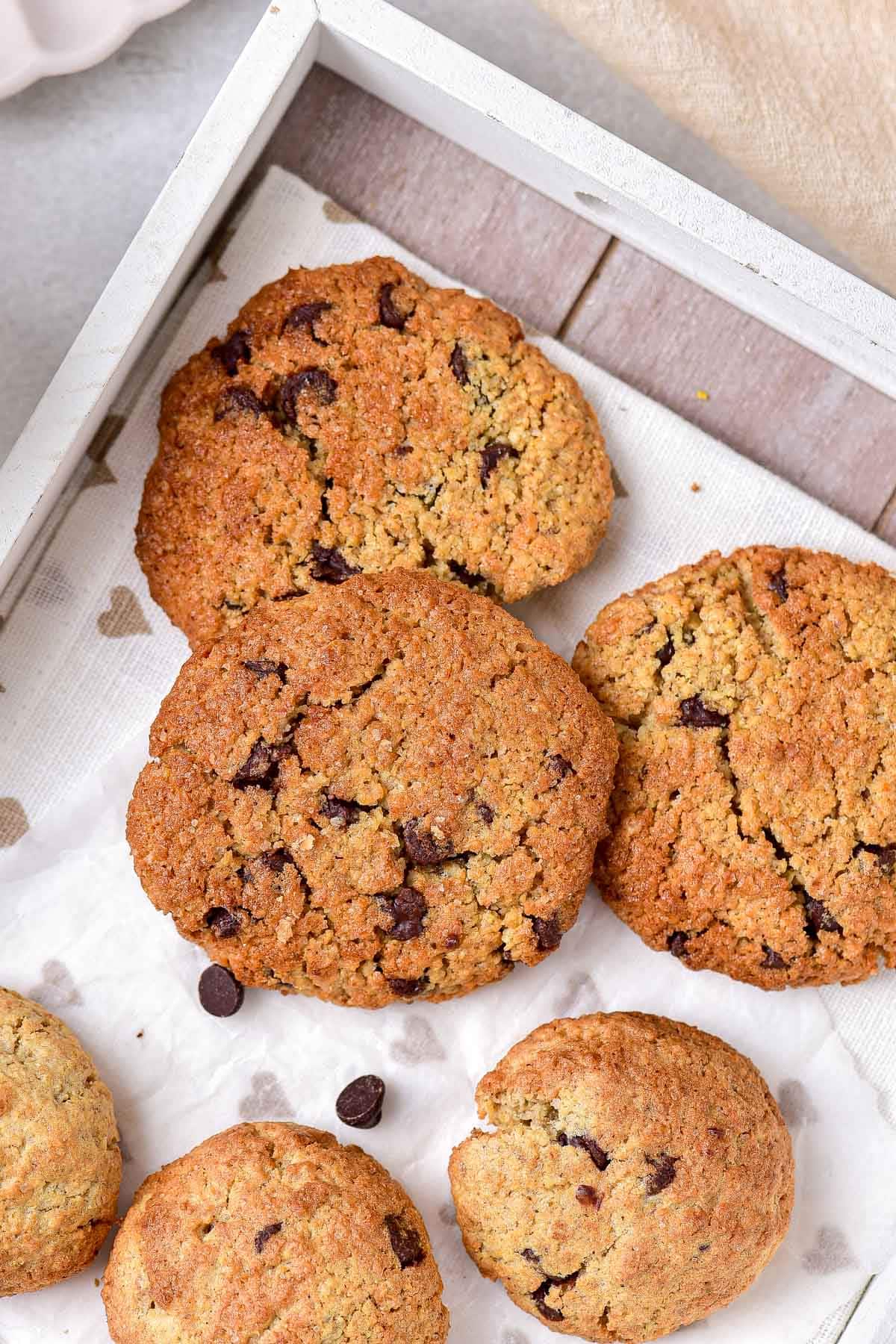 baked oatmeal cookies on tray lined with parchment paper.