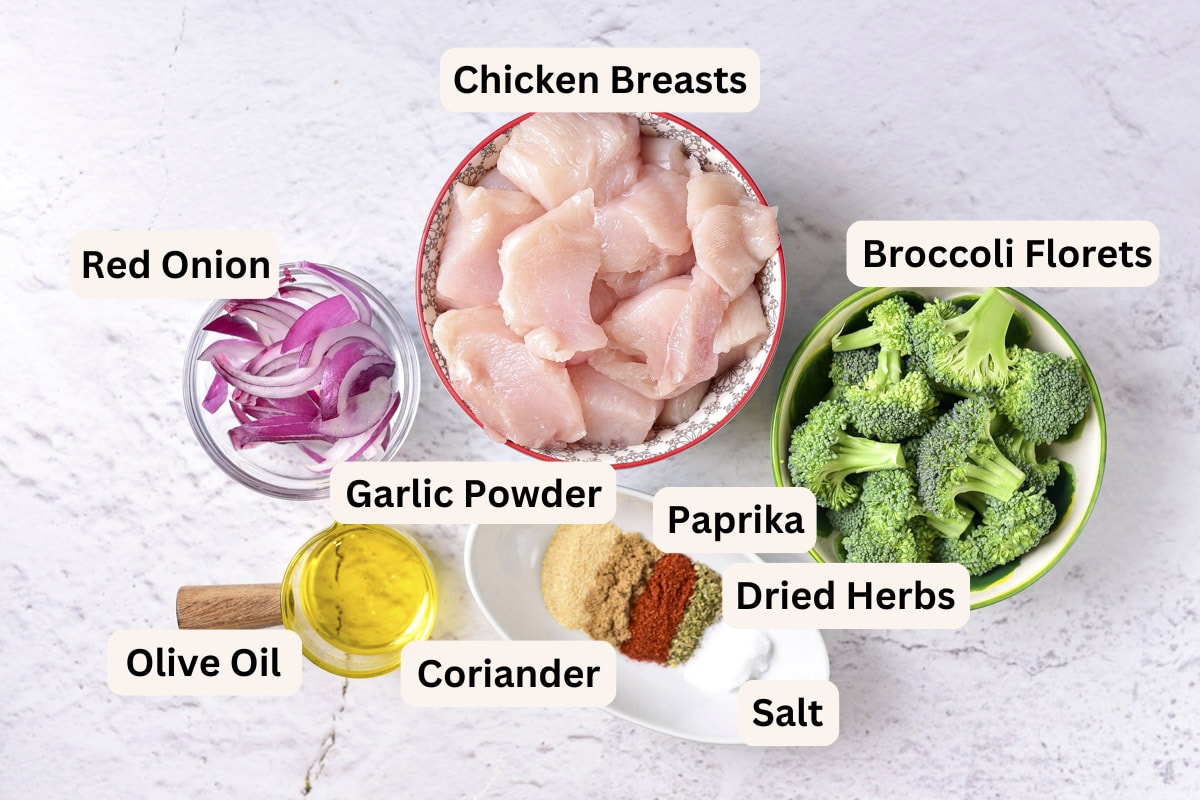 ingredients in bowls on counter with labels to make air fryer chicken and broccoli.
