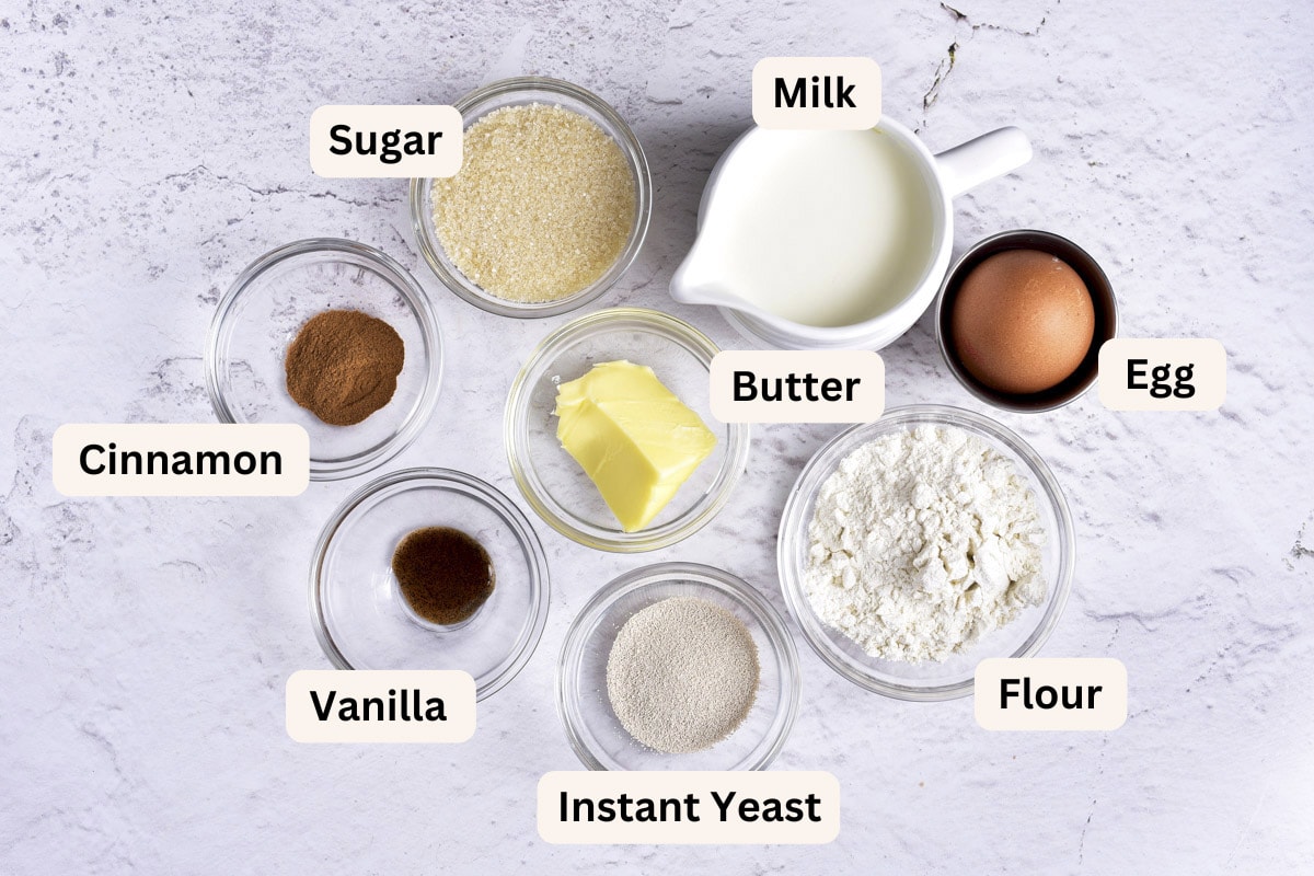 ingredients to make donut holes in bowls on counter with labels.